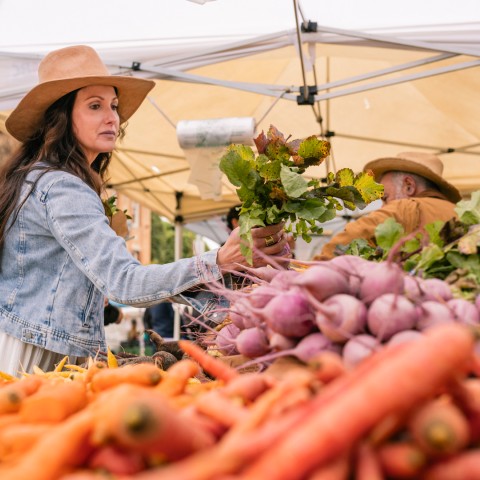 a woman in a hat at a market