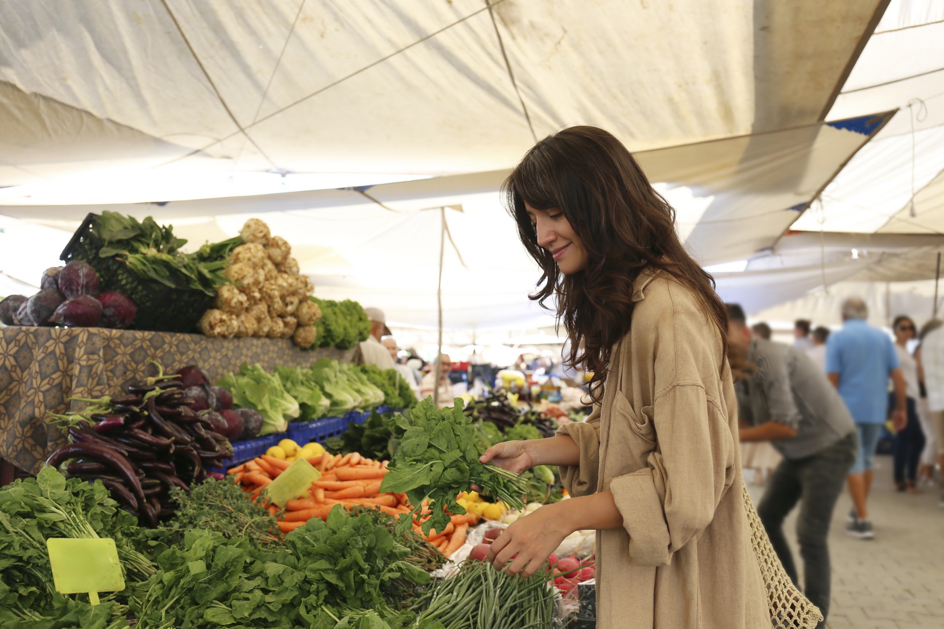 a woman standing in front of a market