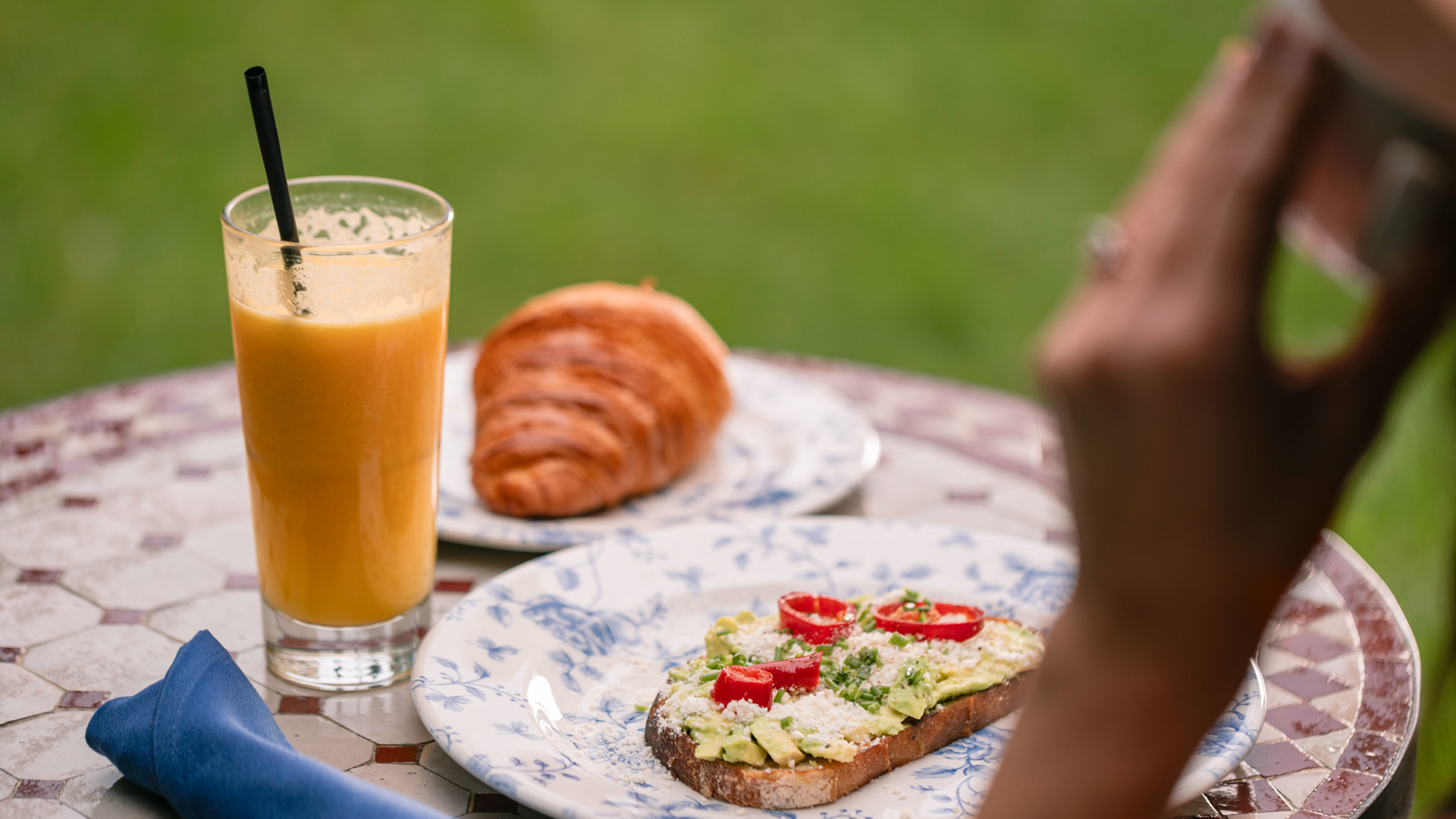 a plate of food and a glass of juice