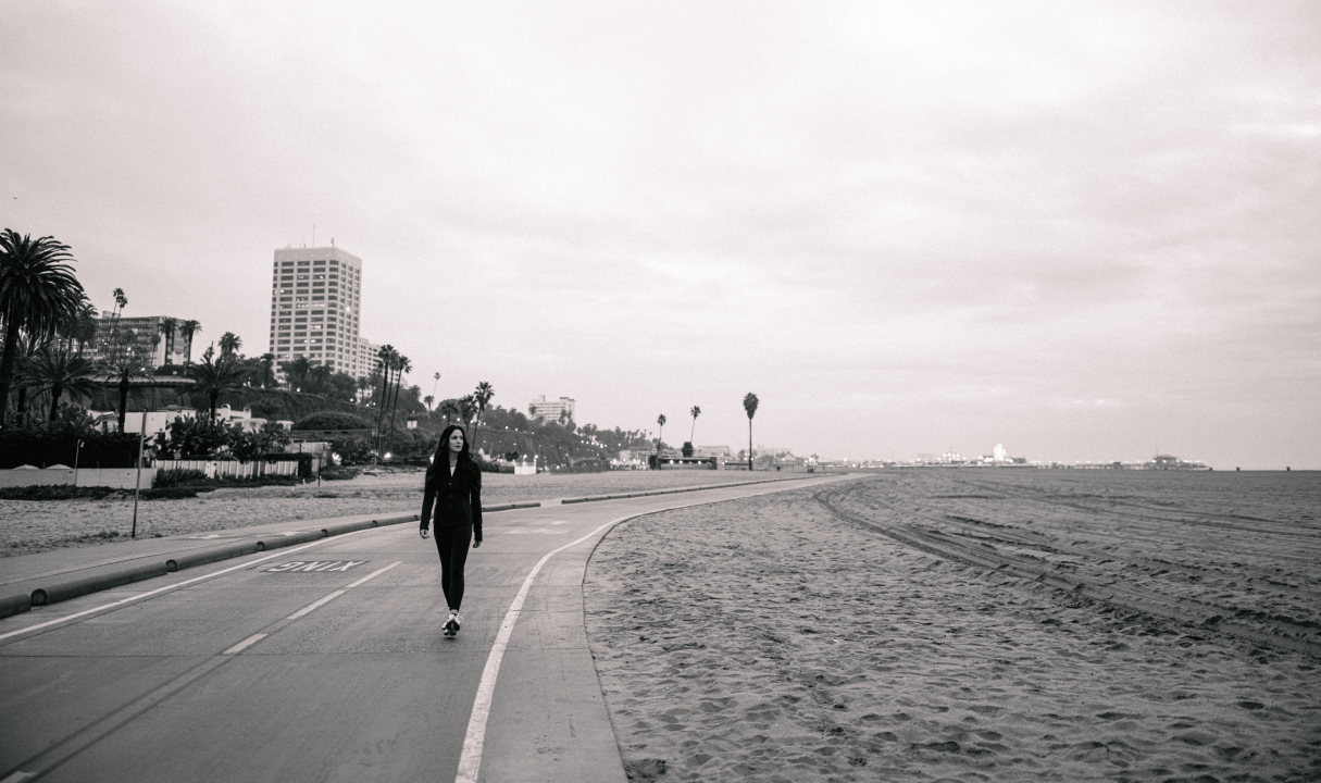 a woman on a skateboard on a beach