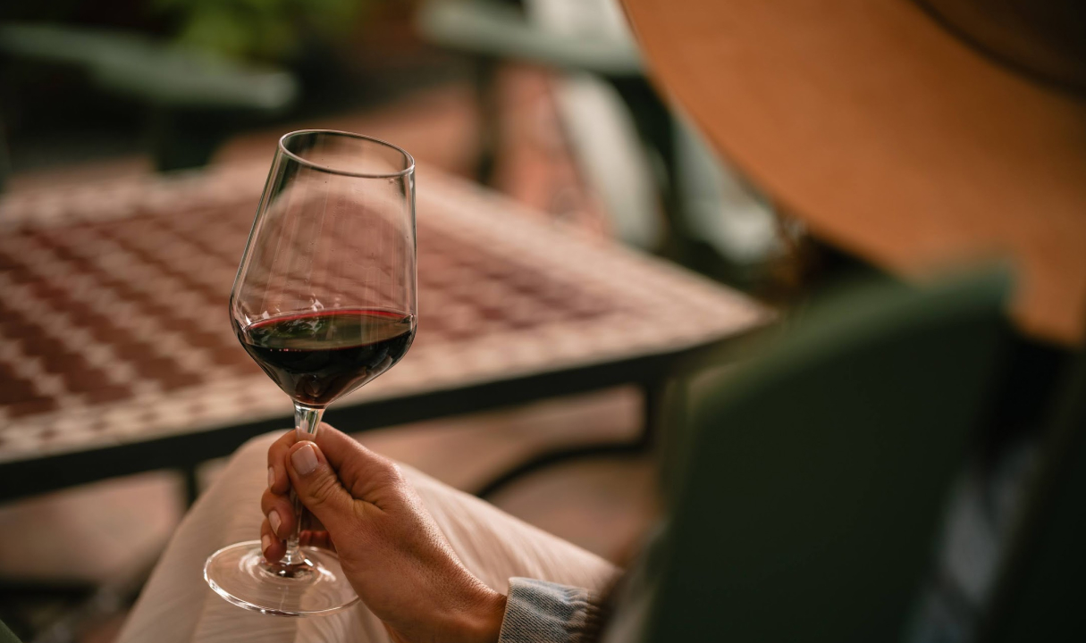 a person holding a glass of wine