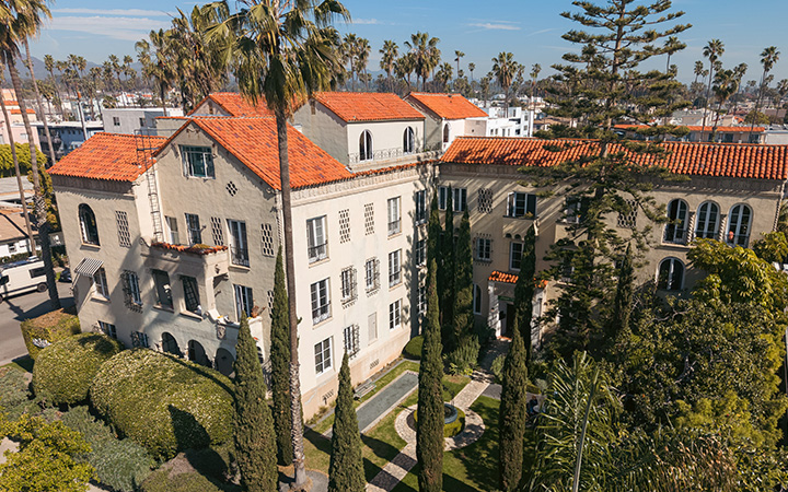 a building with trees and grass