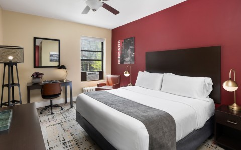 a bedroom with a bed and a fan