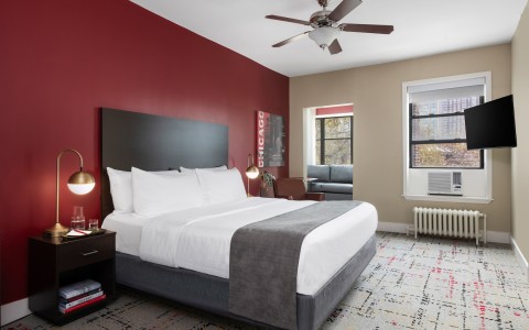 a bedroom with a bed and a fan