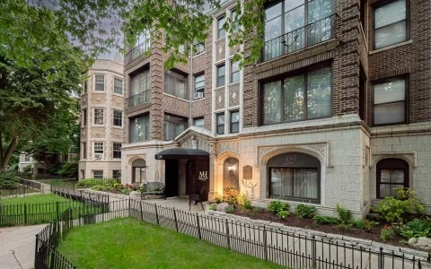 a building with a fence and grass
