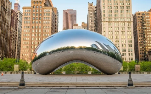 a large reflective object in front of Millennium Park