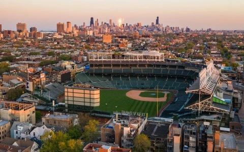 a baseball stadium with a city in the background