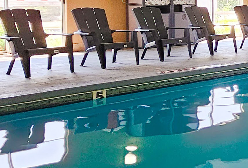 a pool with chairs and a table