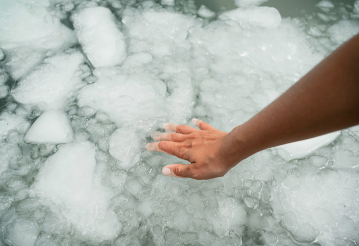 a hand reaching out to ice