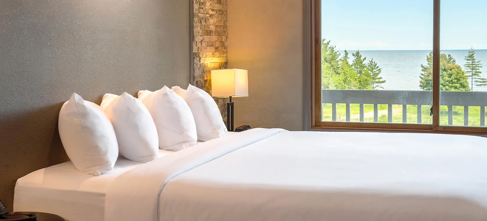a bed with white sheets and a lamp