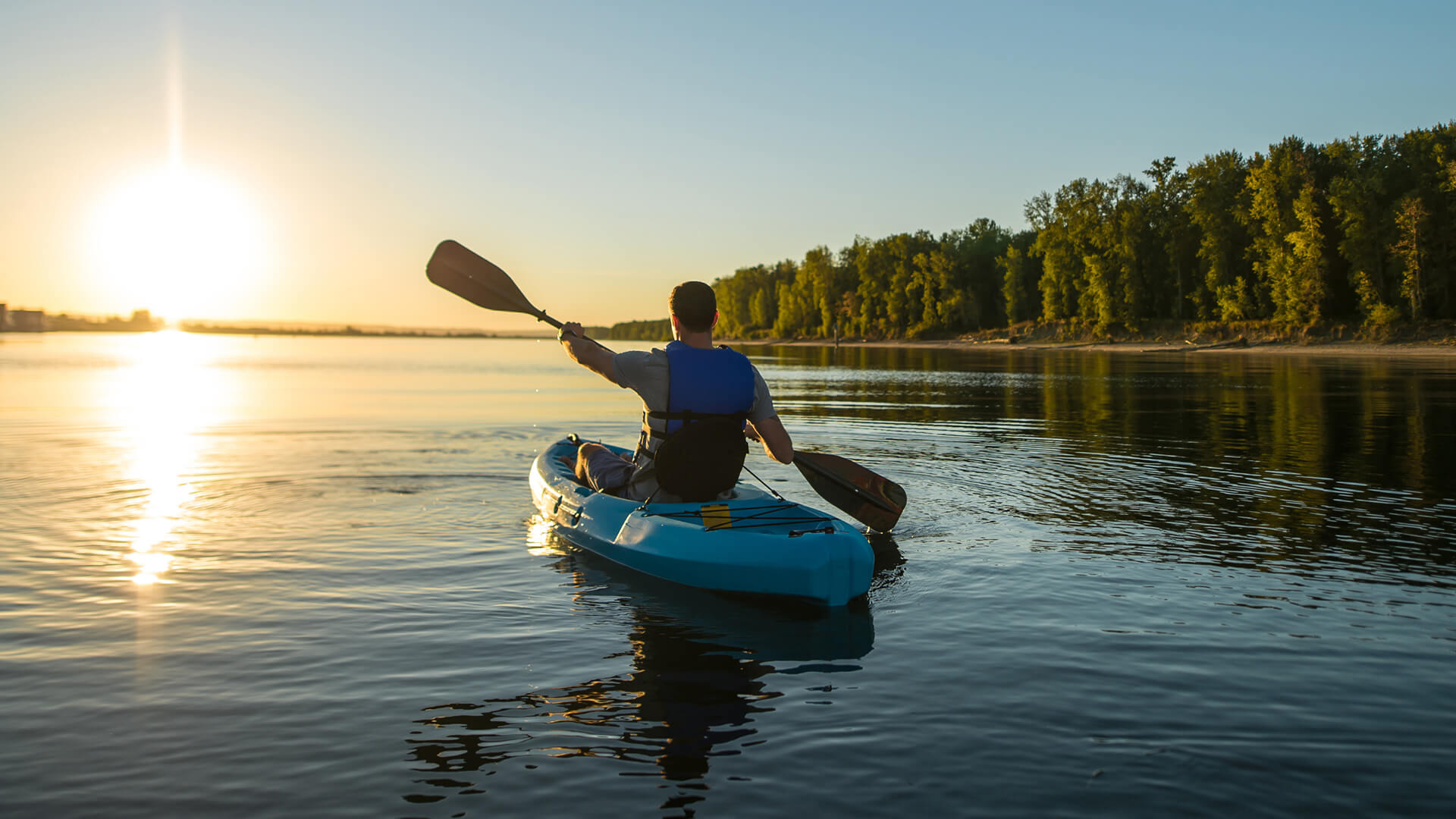 a man in a kayak on a lake