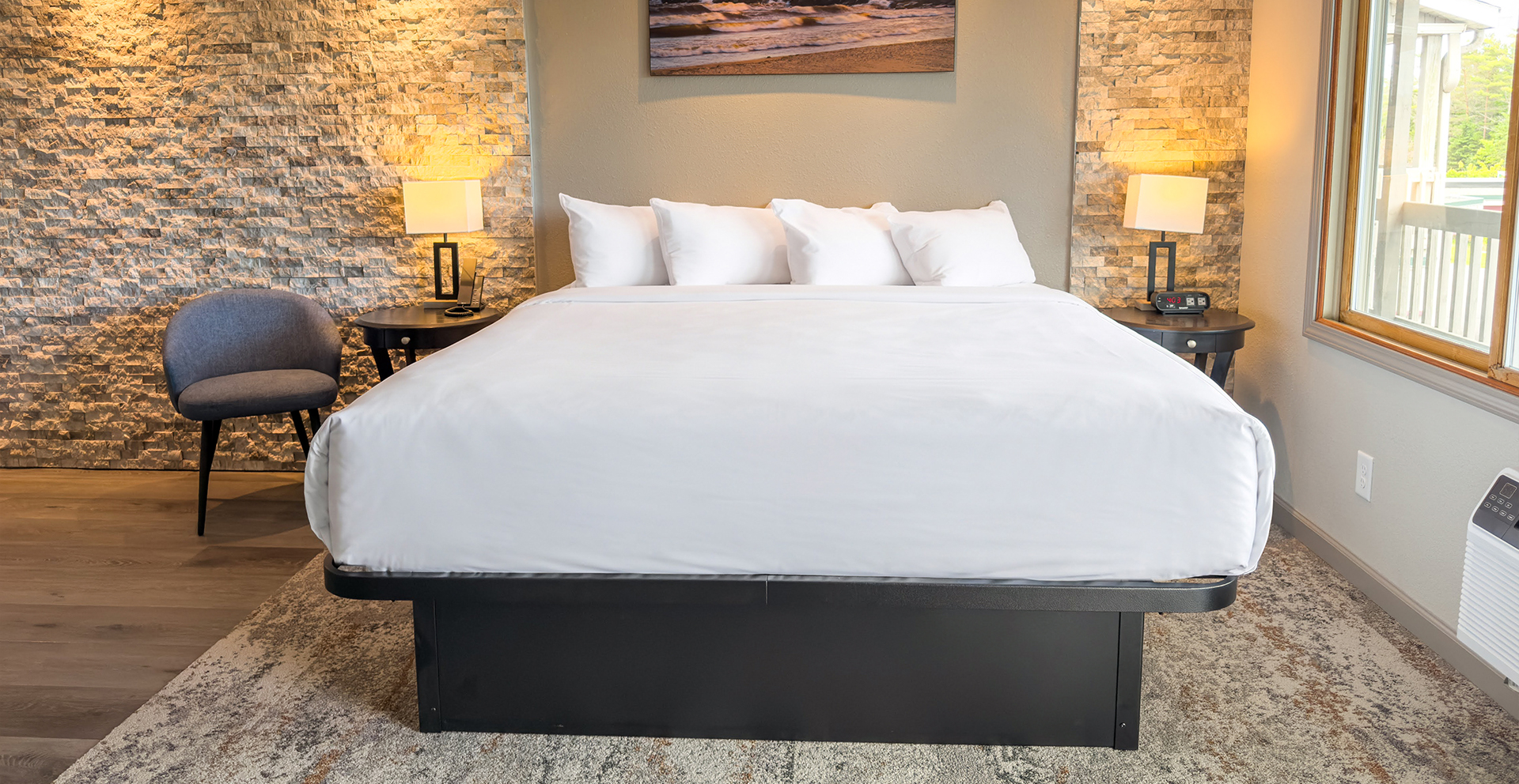 a bed with white sheets and a lamp on the side
