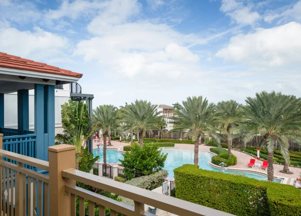 Balcony view of pool with palm trees