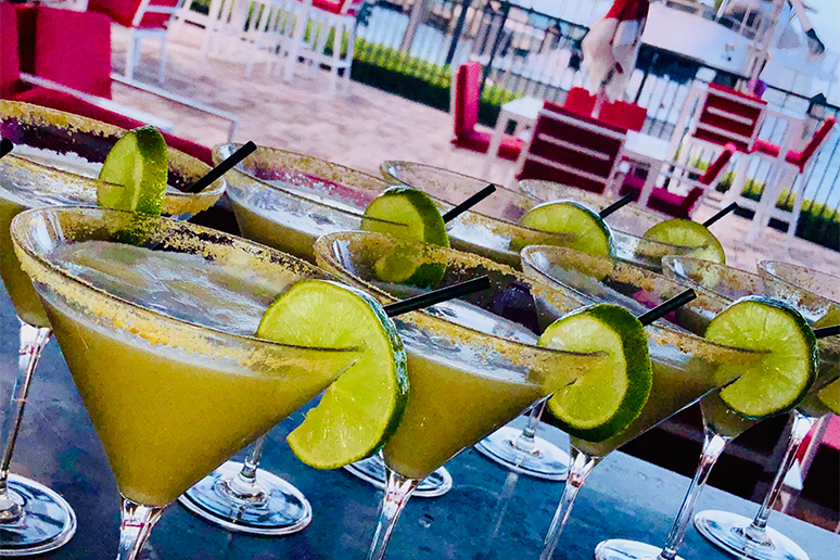 a group of martini glasses with limes on them