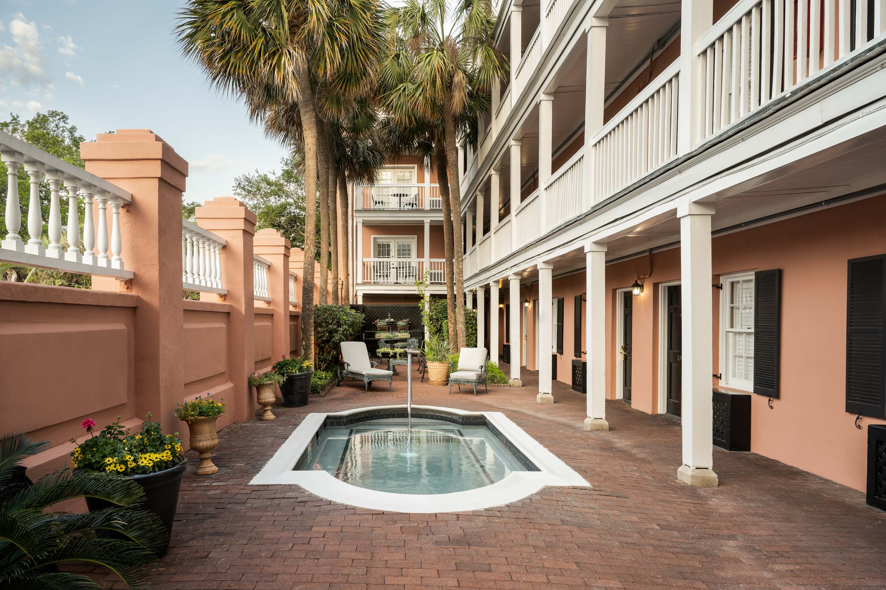 a pool in a courtyard with palm trees
