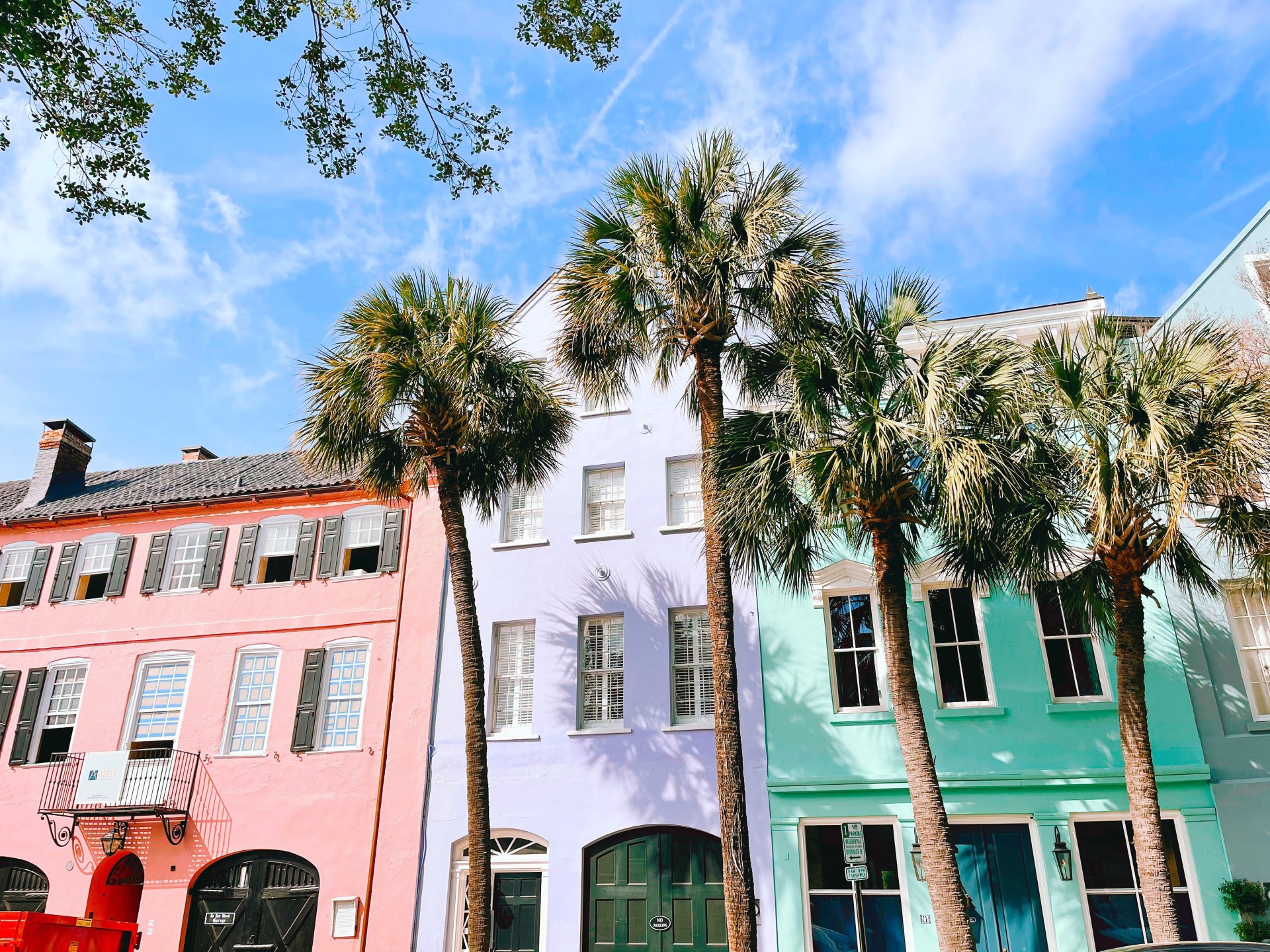 a row of colorful buildings with palm trees