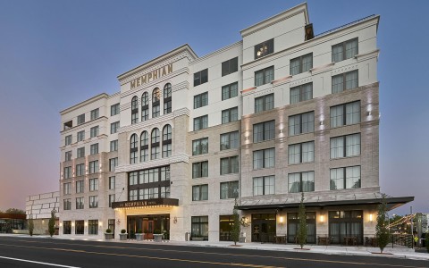 a large building with many windows facing a street