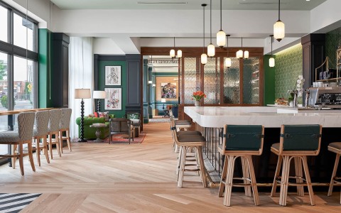 Large room with a white bar and wooden floors