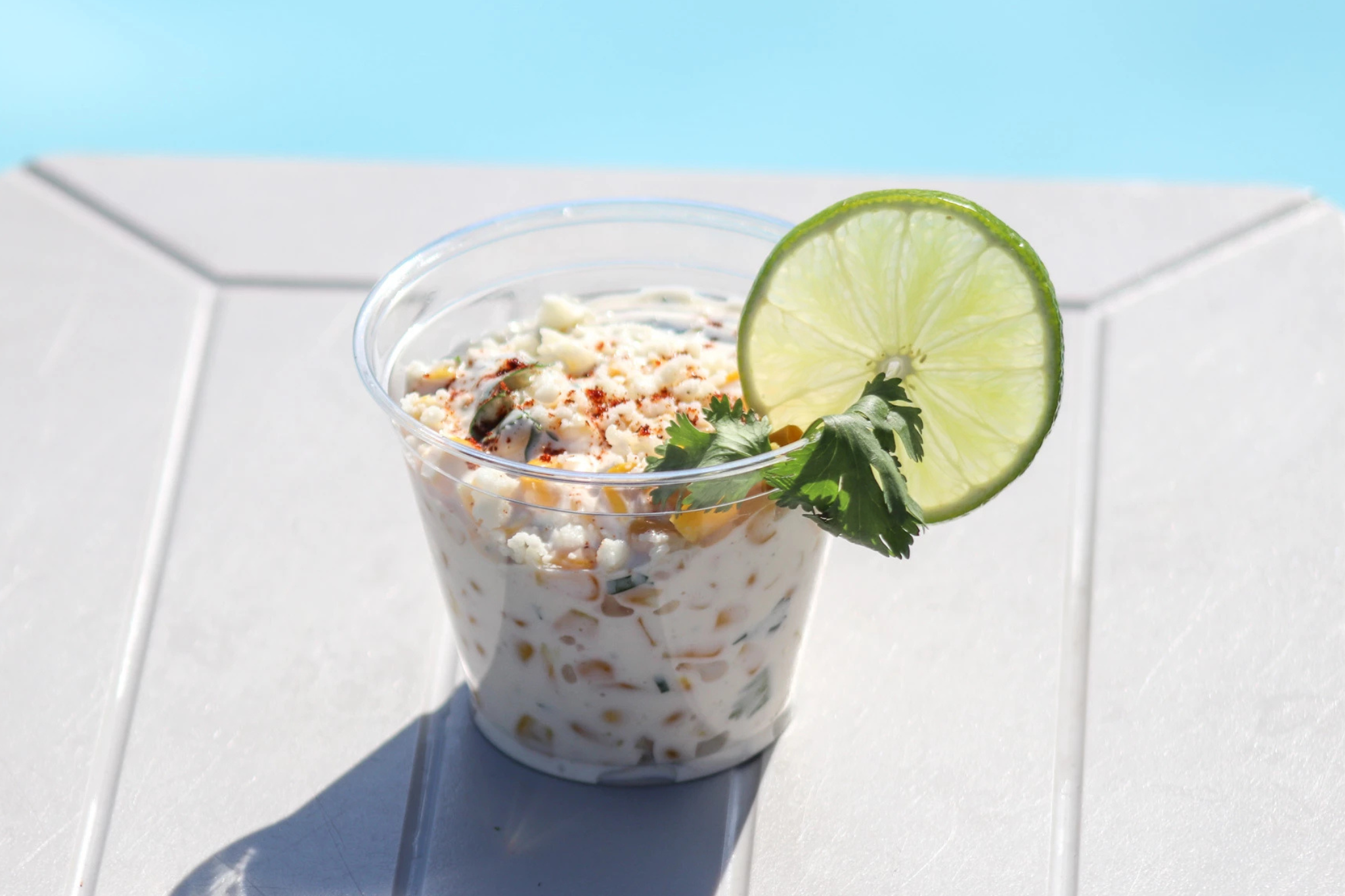 a cup of food with a lime wedge