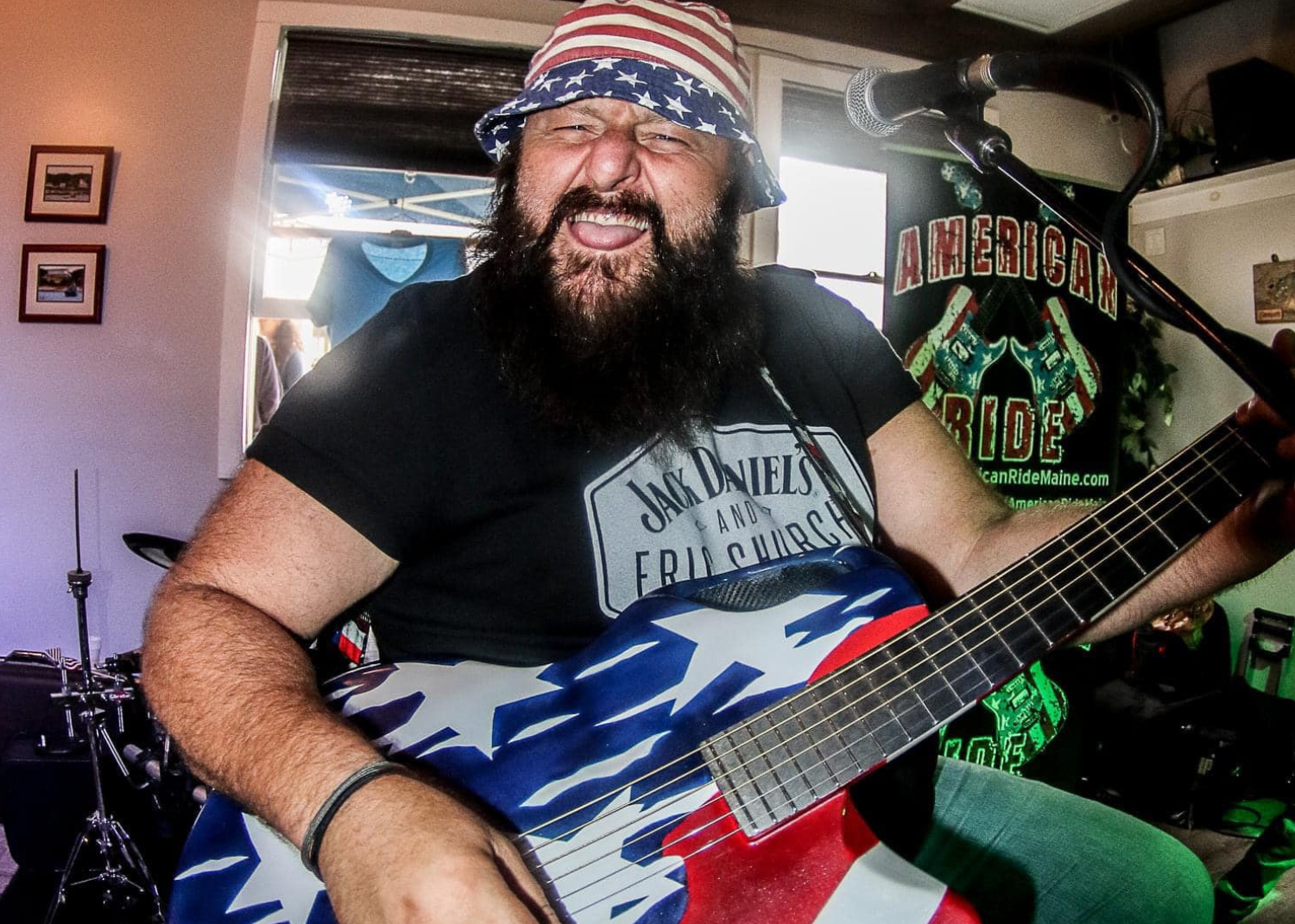 a man with a beard playing a guitar