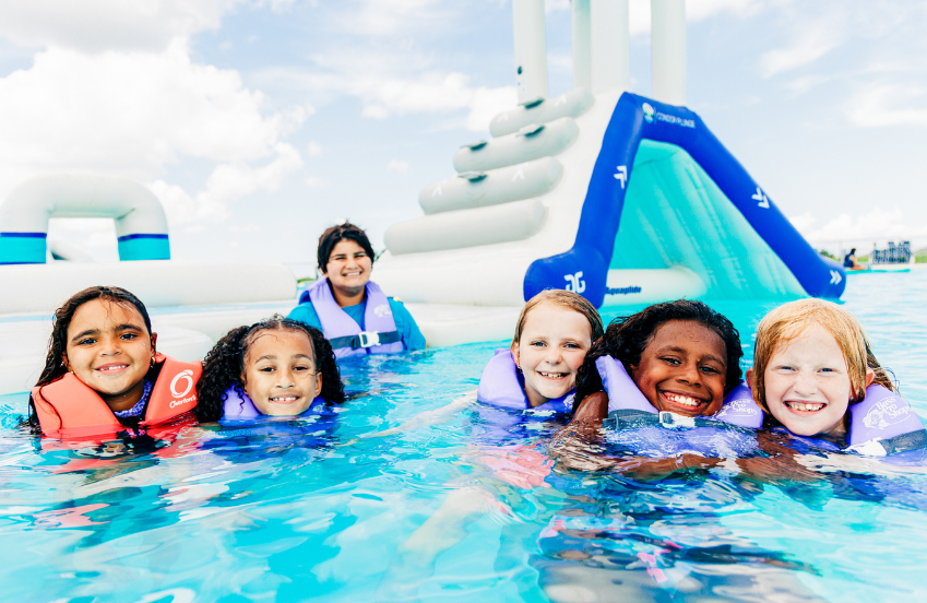 a group of children in a pool