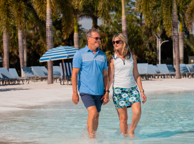 a man and woman walking in water