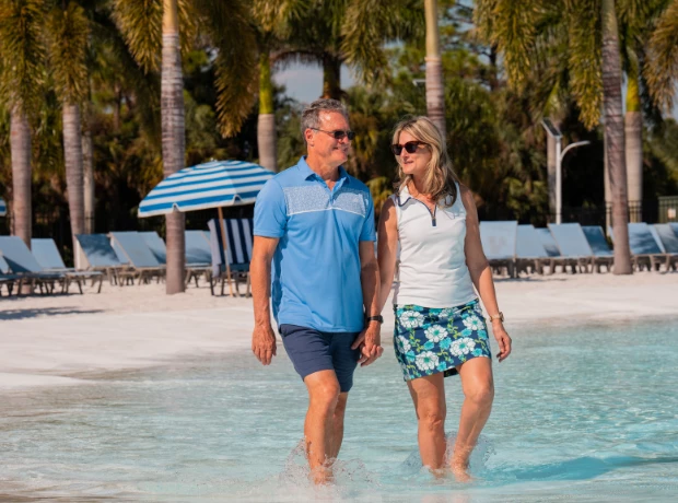 a man and woman walking in water