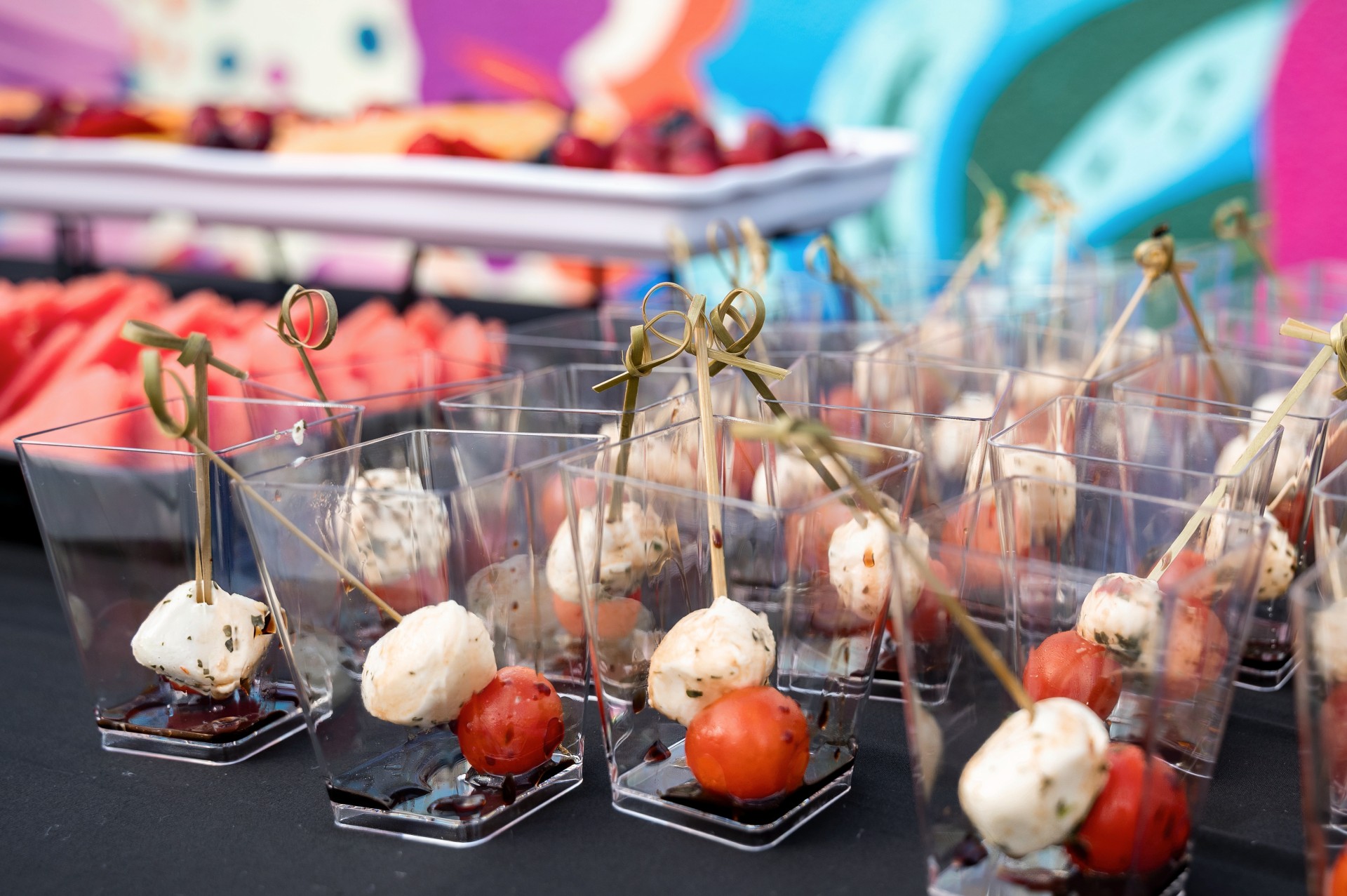 a group of small plastic cups with food on them