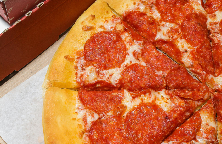 a pepperoni pizza with cheese and sauce