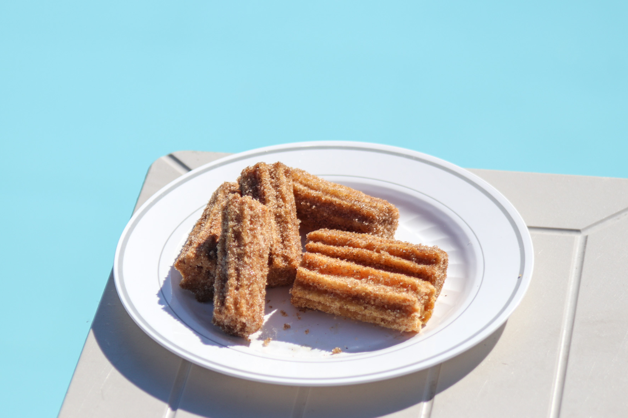 a plate of churros on a table