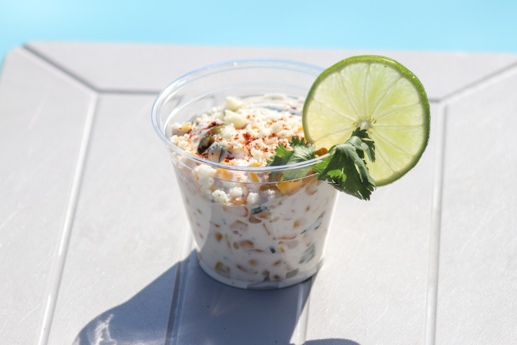 a cup of food with a lime wedge