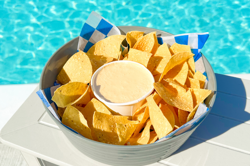 a bowl of chips with dip in it