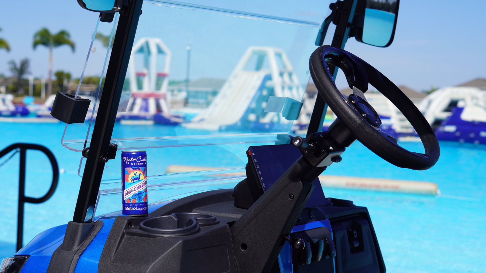 a steering wheel and a can of drink in a pool