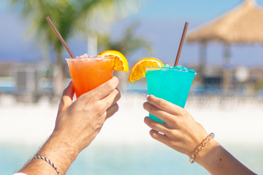 a pair of hands holding drinks
