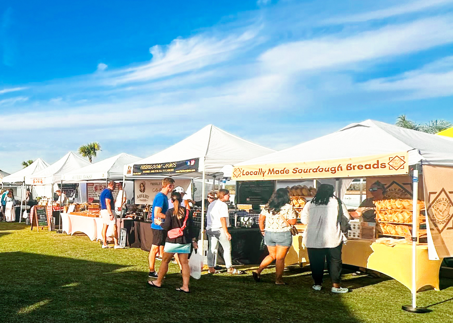 a group of people standing in a line at a food stand