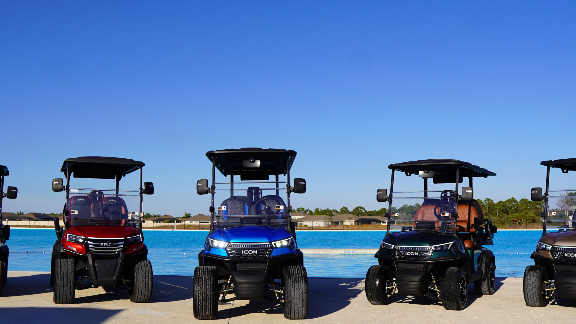a group of golf carts parked next to a pool