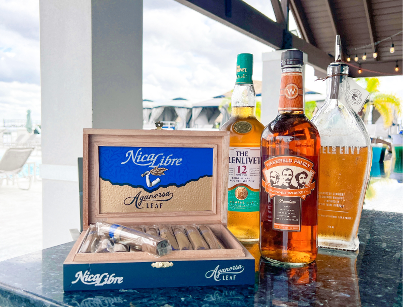 a group of bottles of alcohol and cigars on a table
