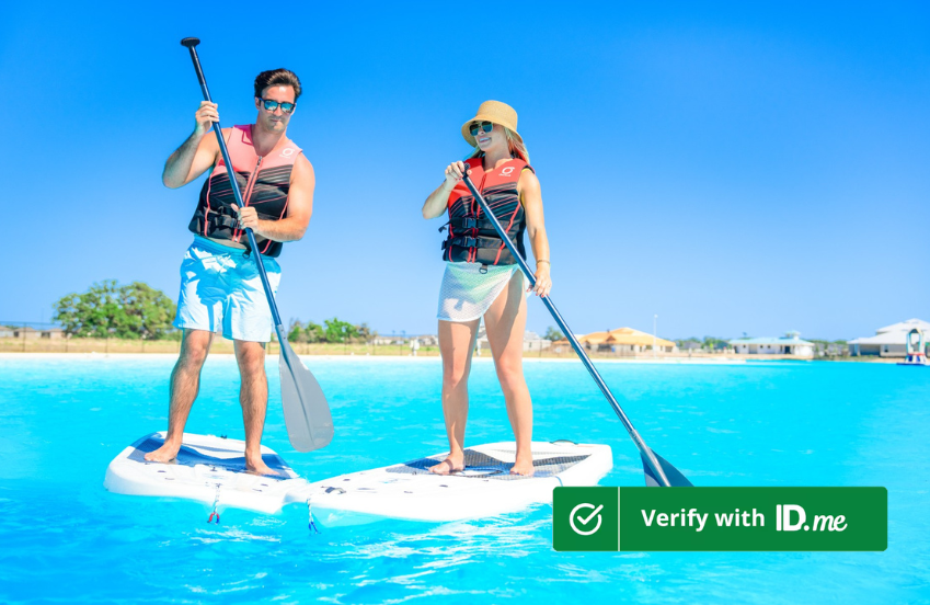 a man and woman on paddle boards in water