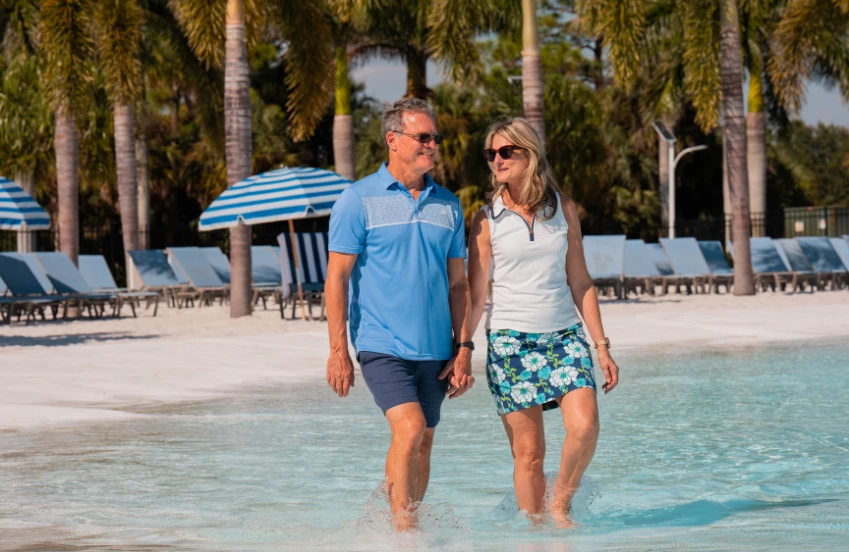 a man and woman walking in water
