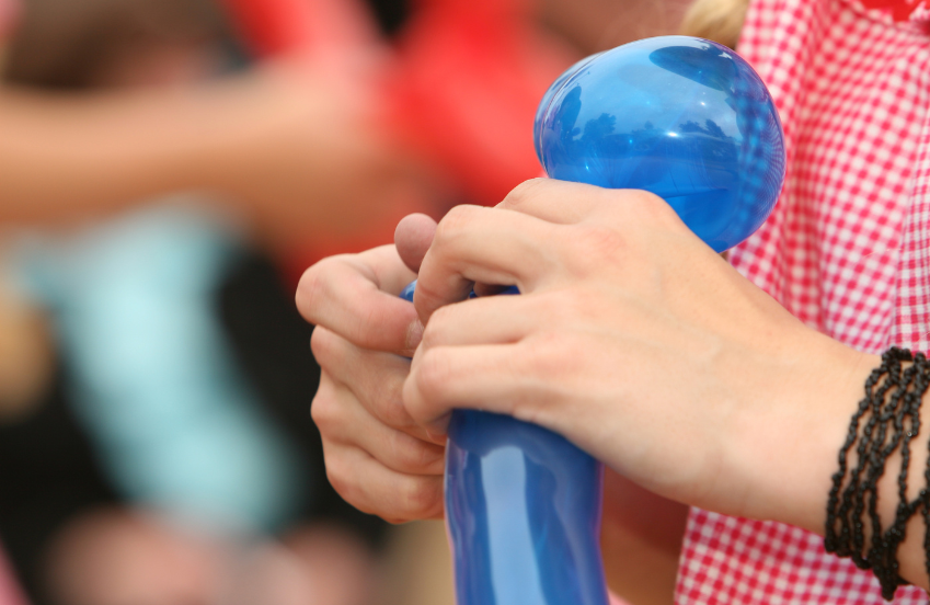 a close up of a person holding a balloon
