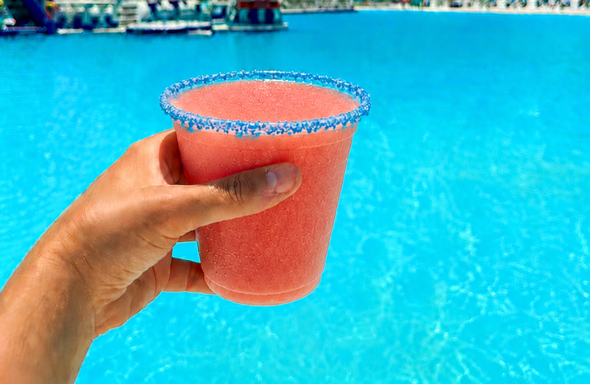 a hand holding a drink