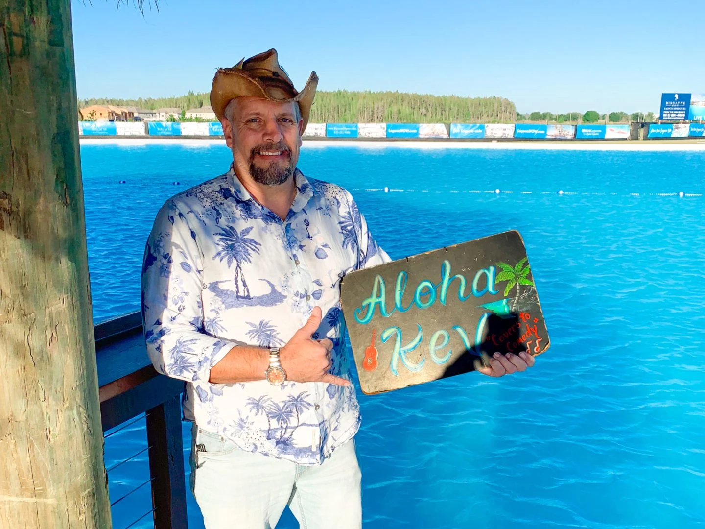 a man in a cowboy hat holding a sign