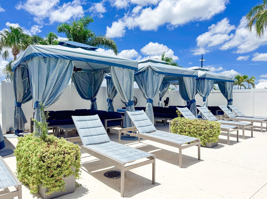 a group of lounge chairs with blue curtains
