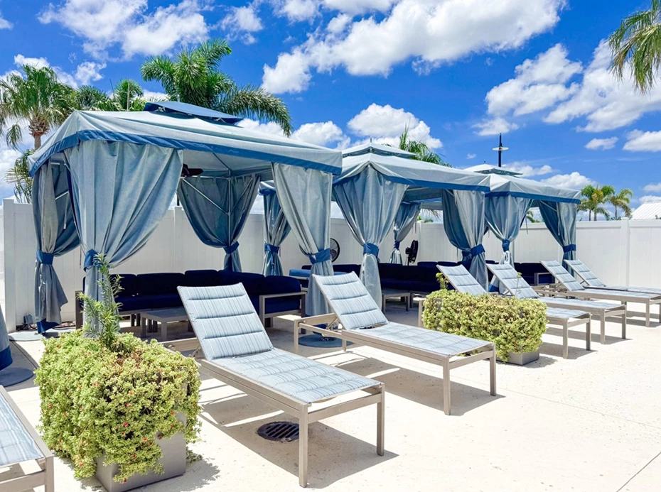 a group of lounge chairs with blue curtains