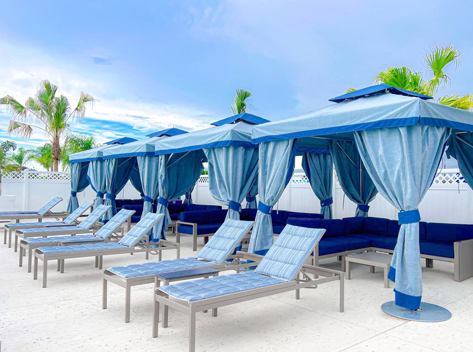 a group of blue chairs and umbrellas on a patio