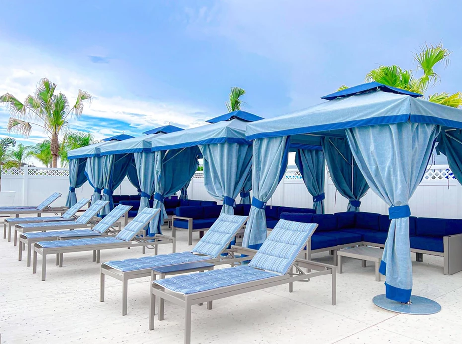 a group of blue chairs and umbrellas on a patio