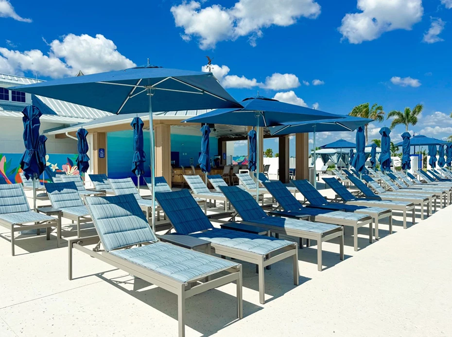a group of lounge chairs and umbrellas outside
