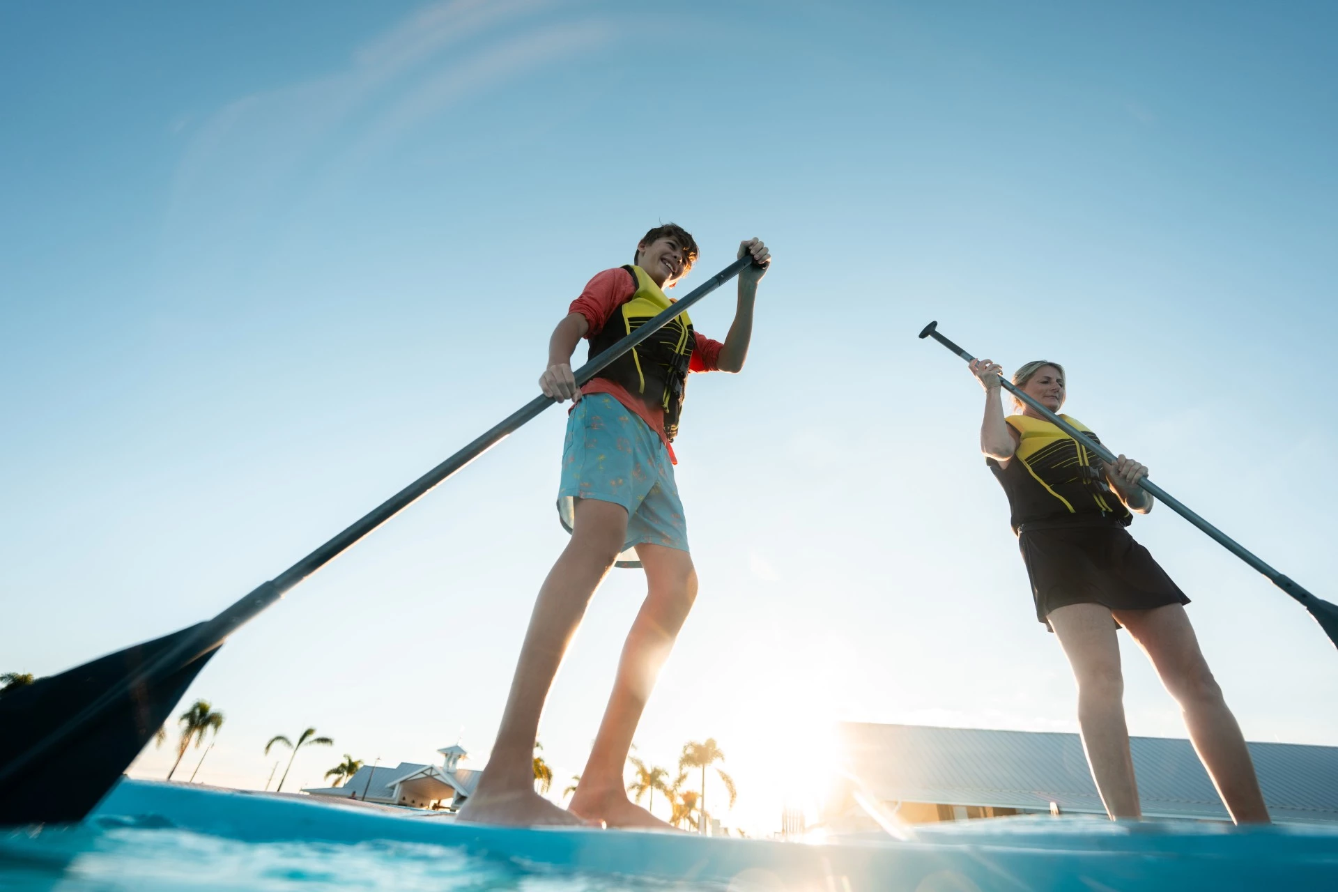 a couple of people on paddle boards