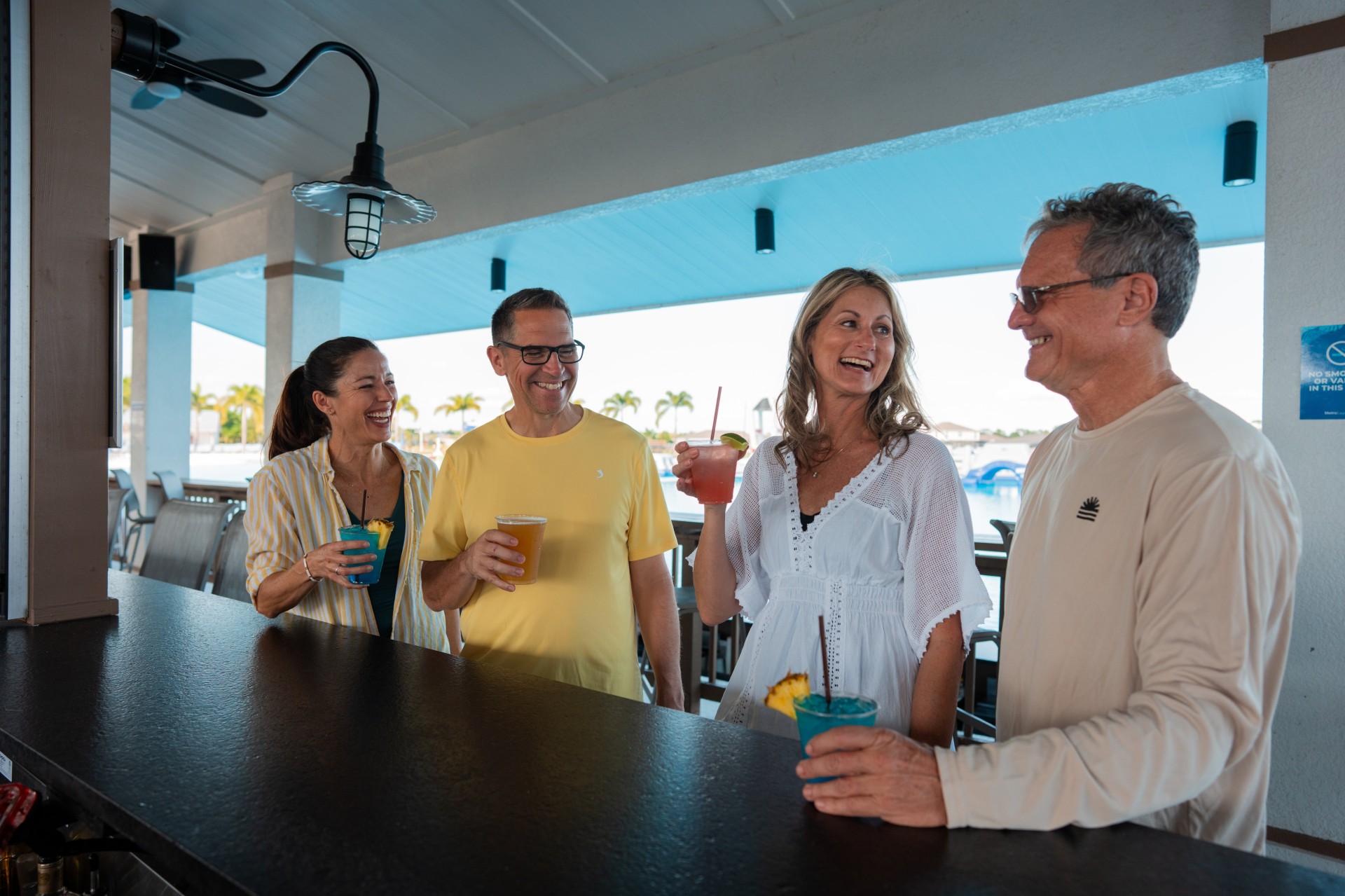 a group of people standing at a bar