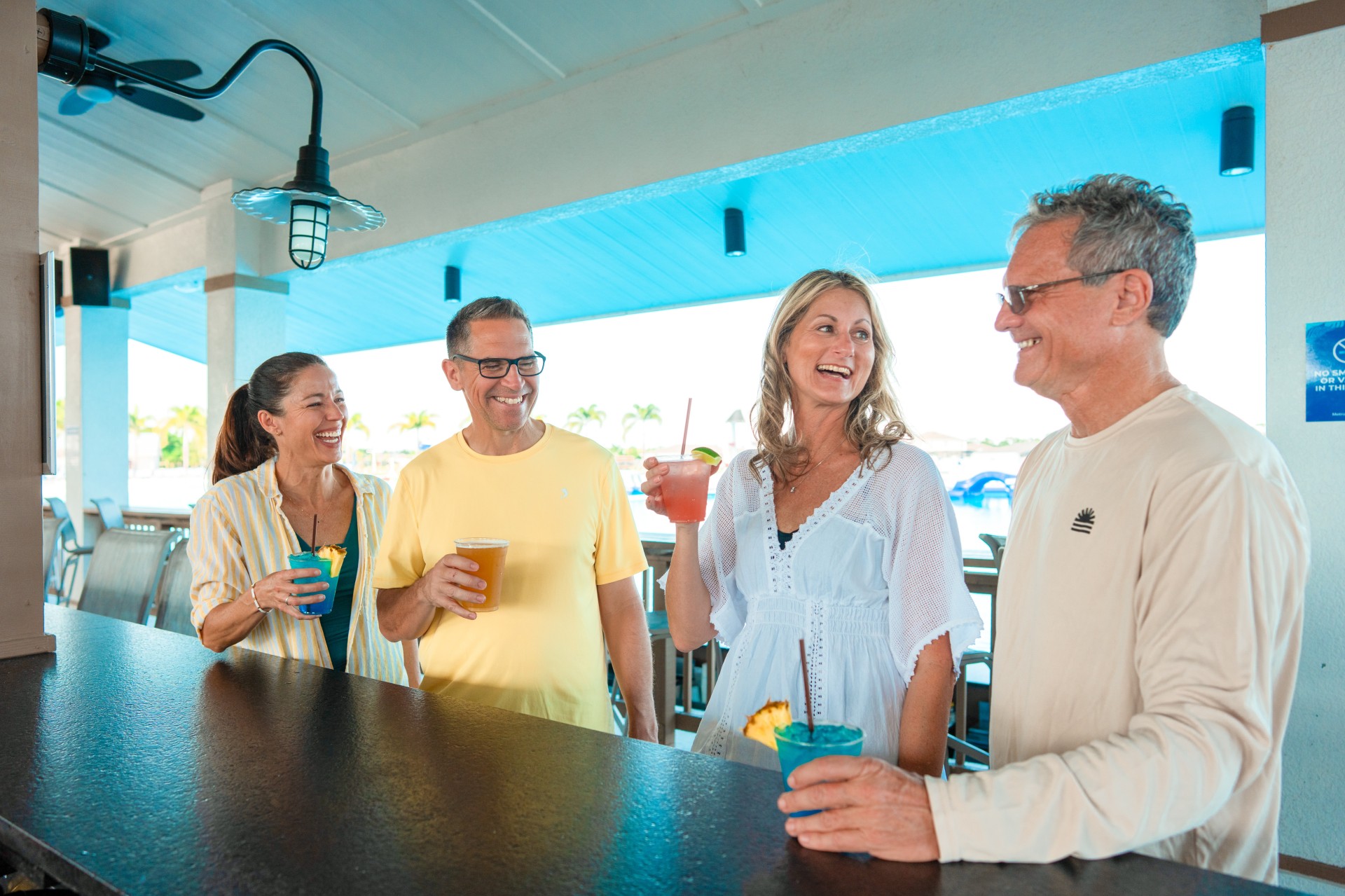 a group of people standing at a bar